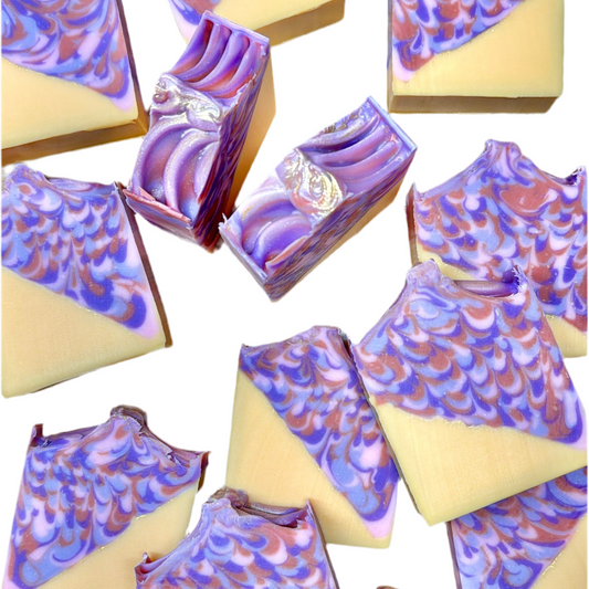 Decorative soap bars with purple and pink marbled design on a white background